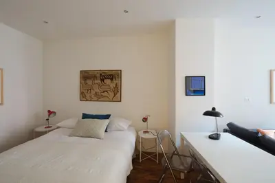 two beds in a room with white walls at Modern pied a terre near Piazza Navona in Rome