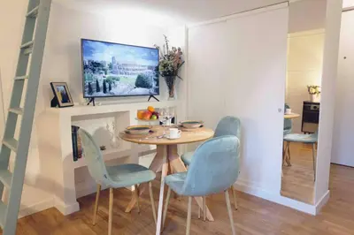 a dining room with a table and blue chairs at Urbana Suite in Rome