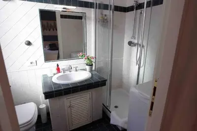 a bathroom with a sink and a shower and a toilet at Urbana Suite in Rome