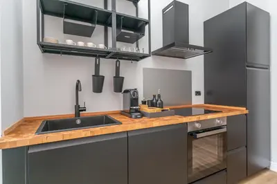 a kitchen with a sink and a counter top at Daplace - Livia Apartment in Rome