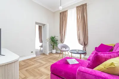 a living room with a pink couch at Daplace - Livia Apartment in Rome