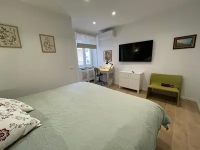 a bedroom with a bed and a tv on the wall at San Paolo Inn in Rome