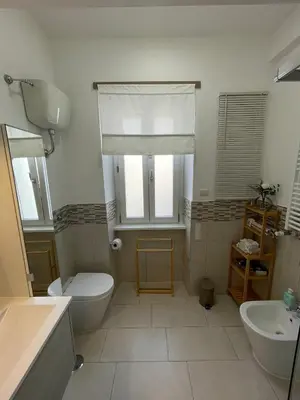 a bathroom with a toilet and a sink at San Paolo Inn in Rome
