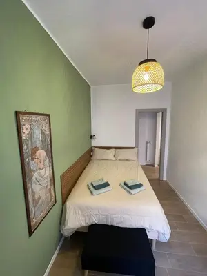 a bedroom with a bed with two towels on it at San Paolo Inn in Rome