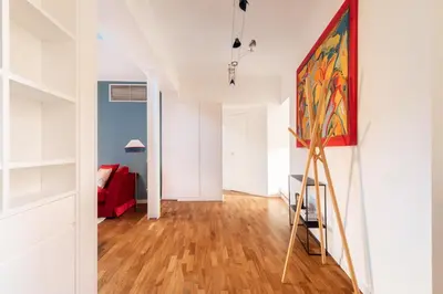 a living room with a painting on the wall at Casa Angelica, a Burghesius home in Rome