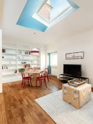 a living room with a table and chairs and a skylight at Casa Angelica, a Burghesius home in Rome