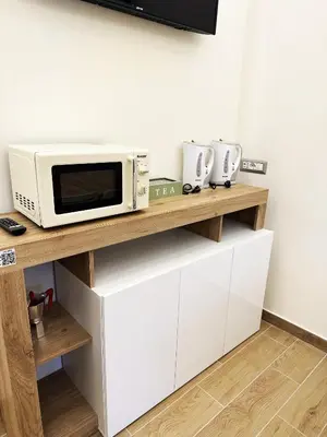 a microwave oven sitting on top of a wooden shelf at MUSEUM DAY VATICAN in Rome