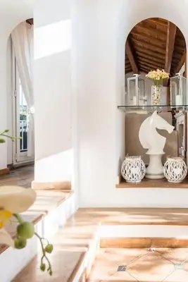 a living room with white walls and wooden floors at Piazza Navona - Penthouse in the heart of Rome in Rome