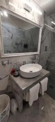 a bathroom with a sink and a mirror at Piazza Navona - Penthouse in the heart of Rome in Rome
