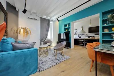 a living room with a blue couch and chairs at Amazing penthouse in the heart of Rome in Rome