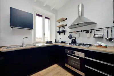 a kitchen with a sink and a stove at Amazing penthouse in the heart of Rome in Rome