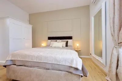 a bedroom with a large bed and two lamps at Amazing penthouse in the heart of Rome in Rome