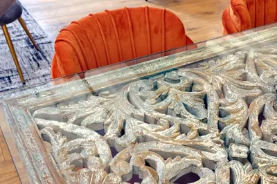 a glass table with an orange chair in a room at Amazing penthouse in the heart of Rome in Rome