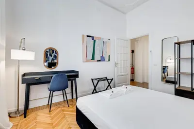 a bedroom with a bed and a desk at BMGA l Gracchi Lux Lovely 3Bdr Apartment in Rome