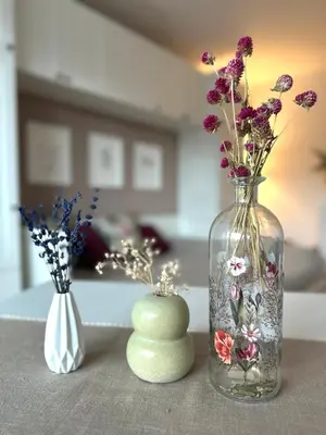 two vases with flowers in them sitting on a table at Hygge Studio in Rome