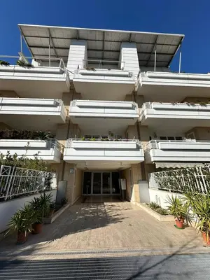 an external view of a white building with plants at Hygge Studio in Rome