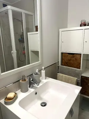 a bathroom with a white sink and a mirror at Hygge Studio in Rome