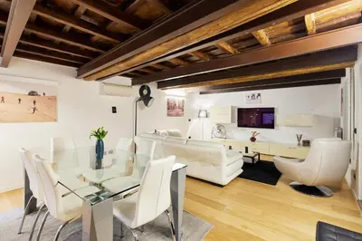 a living room with a glass table and white chairs at iFlat Marvellous home near Via del Corso in Rome