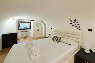 a large white bed in a room with a window at iFlat Marvellous home near Via del Corso in Rome