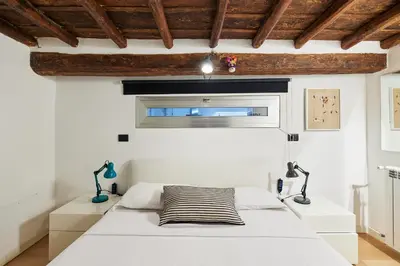 a bedroom with a white bed and a window at iFlat Marvellous home near Via del Corso in Rome