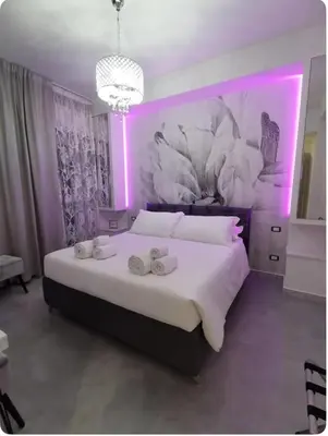 a bedroom with a large bed with purple lighting at Dulcis in Fundo in Rome