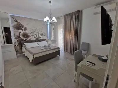 a living room with a bed and a table and a room at Dulcis in Fundo in Rome