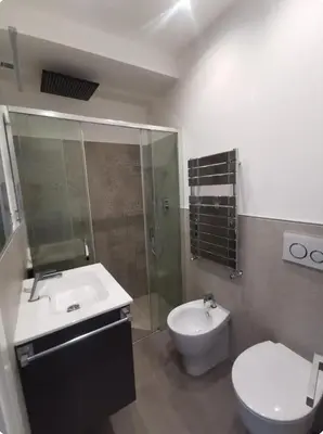 a bathroom with a sink and a toilet and a shower at Dulcis in Fundo in Rome
