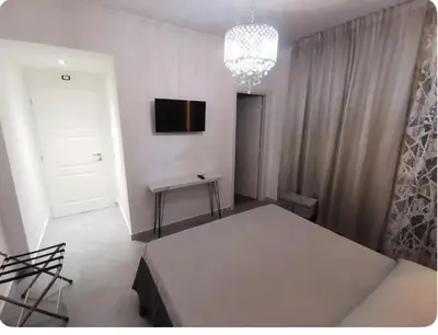 a white room with a table and a television on the wall at Dulcis in Fundo in Rome