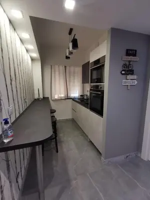 a kitchen with a table and a counter top at Dulcis in Fundo in Rome