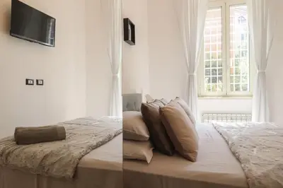 a bedroom with a bed and a television on the wall at San Pietro - moderno appartamento in Rome