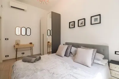 a bedroom with a large white bed with white pillows at San Pietro - moderno appartamento in Rome