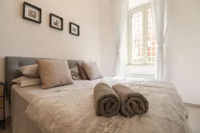 a bedroom with a bed with two towels on it at San Pietro - moderno appartamento in Rome