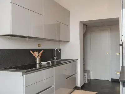 a kitchen with white cabinets and a sink at Apartment Le Colonne by Interhome in Rome