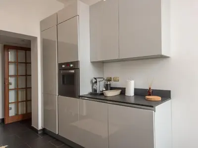 a kitchen with white cabinets and a stove at Apartment Le Colonne by Interhome in Rome