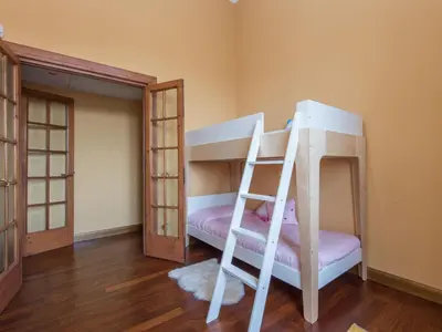 a bunk bed with a ladder in a room at Apartment Le Colonne by Interhome in Rome