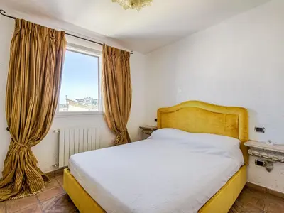a bedroom with a bed and a window at Apartment Santa Cecilia View by Interhome in Rome