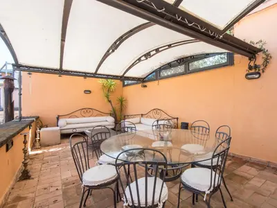 a dining room with a table and chairs at Apartment Santa Cecilia View by Interhome in Rome