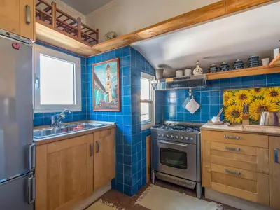 a blue tiled kitchen with a stove and a sink at Apartment Santa Cecilia View by Interhome in Rome