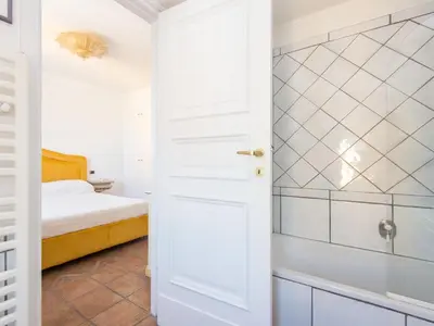 a white bathroom with a bed and a shower at Apartment Santa Cecilia View by Interhome in Rome