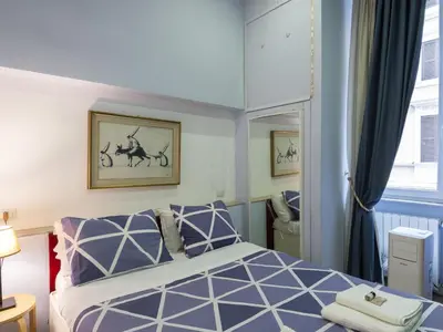 a bedroom with a bed and a mirror at Apartment Porta Magica by Interhome in Rome