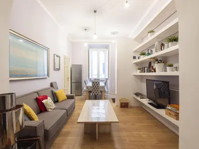 a living room with a couch and a table at Apartment Porta Magica by Interhome in Rome