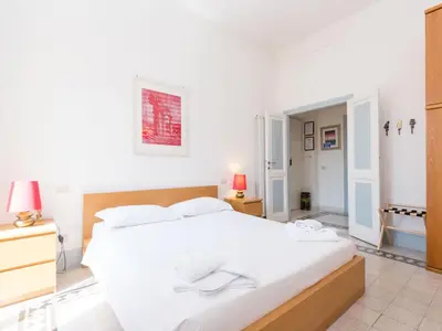 a white bedroom with a large white bed in it at Apartment Angelico by Interhome in Rome