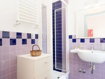 a bathroom with purple tiles and a sink at Apartment Angelico by Interhome in Rome