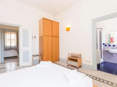 a bedroom with a bed and a bathroom with a sink at Apartment Angelico by Interhome in Rome