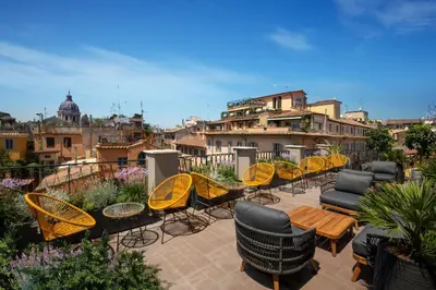 a group of chairs and tables on a balcony at Condotti Belvedere in Rome