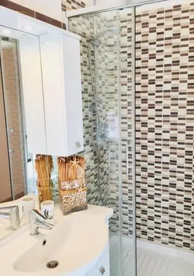 a bathroom with a sink and a glass shower at Maison de' Trastevere in Rome