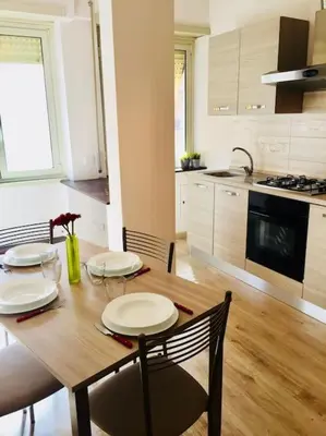 a kitchen with a wooden table with two plates on it at Maison de' Trastevere in Rome