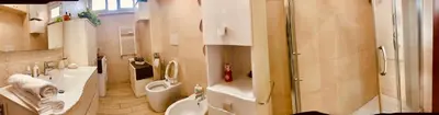 a bathroom with a toilet and a sink and a shower at Family in Rome in Rome