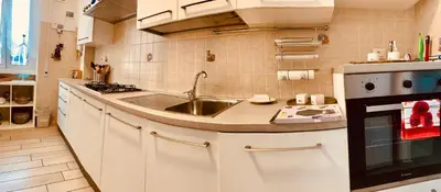 a small kitchen with a sink and a stove at Family in Rome in Rome