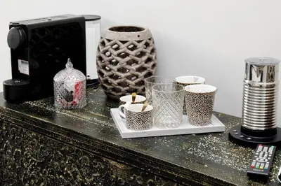 a counter with several cups and a coffee maker at Boutique Suites della Croce in Rome